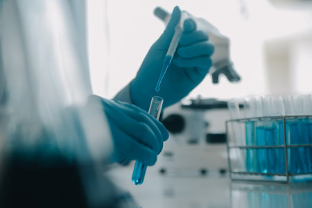 biochemical research scientist team working with microscope for coronavirus vaccine development in pharmaceutical research labolatory, selective focusの写真素材