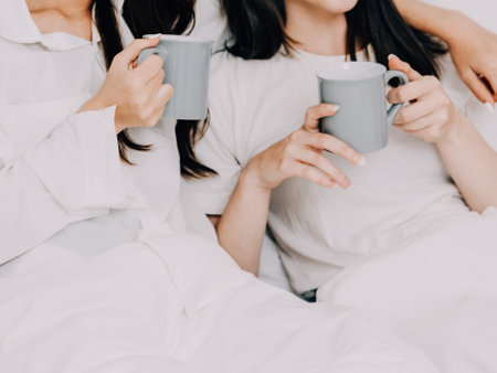 Happy young lesbian couple taking selfie together, Couple of friends relaxing and spending time on weekend at home, Couple of female lovers with good relationship, Concept of LGBTQの写真素材