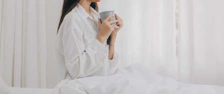 Happy freelance asian woman work on tablet on the hotel bed on travel trip.