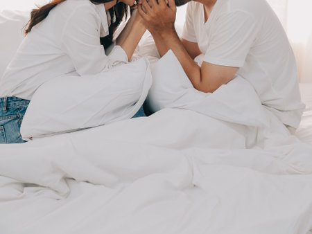 In love new couple at home.Cheerful beautiful young couple relexing on sofa home.Romantict moment.In selective focus. Setup studio shooting.の写真素材