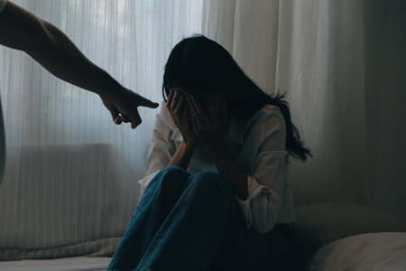Upset woman having a fight with a man at home. Hispanic wife slapping the face of her husband during an argument because of their relationship problemsの写真素材