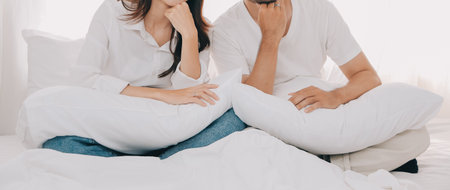 In love new couple at home.Cheerful beautiful young couple relexing on sofa home.Romantict moment.In selective focus. Setup studio shooting.の写真素材