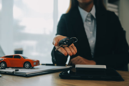 Salesman send key to customer after good deal agreement, successful car loan contract buying or...