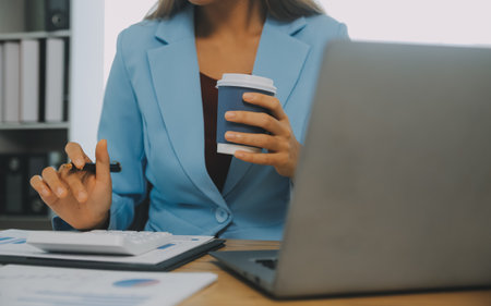 Business team working with new startup project plan and discussion information for financial strategy with laptop and digital tablet in a modern business lounge.の写真素材