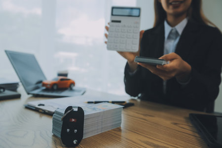 Salesman send key to customer after good deal agreement, successful car loan contract buying or selling new vehicle.の写真素材