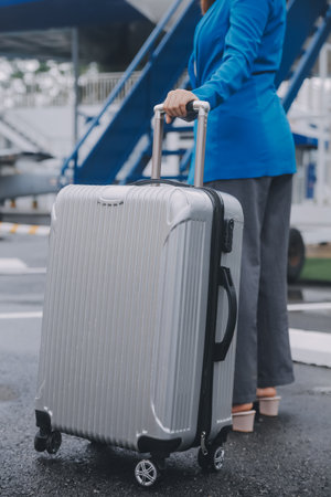 Young asian woman in international airport, using mobile smartphone and checking flight at the...