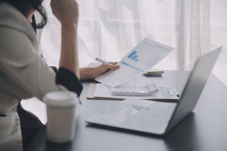 Financial analysts analyze business financial reports on a digital tablet planning investment...