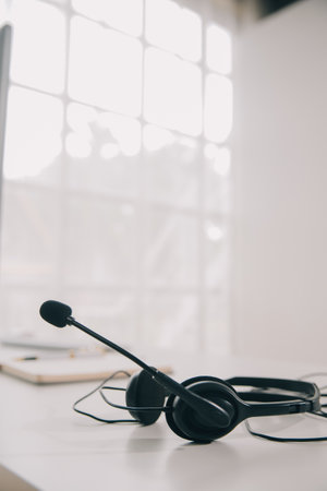 Communication support, call center and customer service help desk. VOIP headset on telephone keyboard.の写真素材