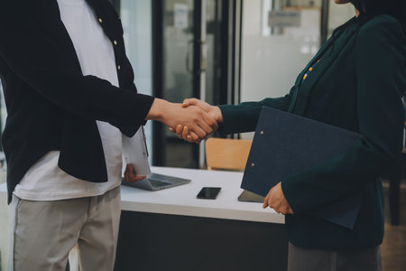 Businessmen join hands at the meeting to congratulate the company's big project on its success and its financial results have made a huge profit for the company, Finance concept.の写真素材
