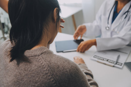 Doctor and patient are discussing consultation about symptom problem diagnosis of disease talk to the patient about medication and treatment method.の写真素材