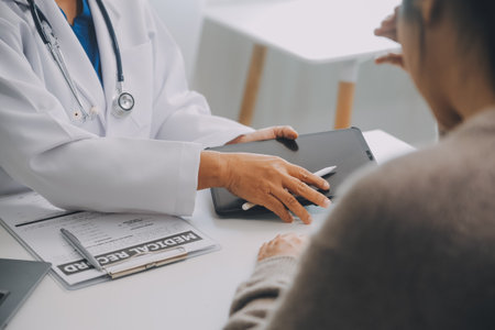 Doctor and patient are discussing consultation about symptom problem diagnosis of disease talk to the patient about medication and treatment method.の写真素材