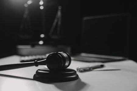 image of judge's hammer, scales lady of justice, law book, laptop computer and contract documents...