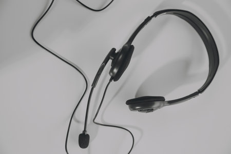 Communication support, call center and customer service help desk. VOIP headset on telephone...