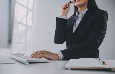 Communication support, call center and customer service help desk. VOIP headset on telephone keyboard.の写真素材