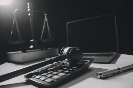 image of judge's hammer, scales lady of justice, law book, laptop computer and contract documents...