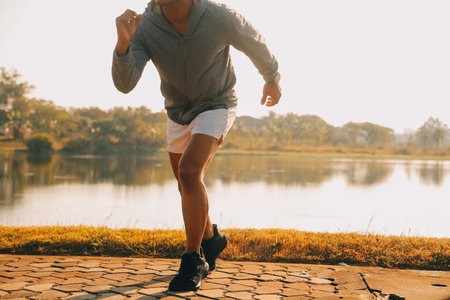 Athlete runner feet running on road, Jogging concept at outdoors. Man running for exercise.