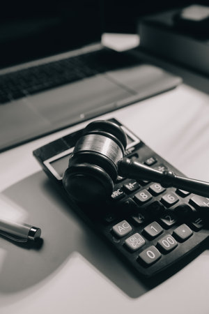 image of judge's hammer, scales lady of justice, law book, laptop computer and contract documents...