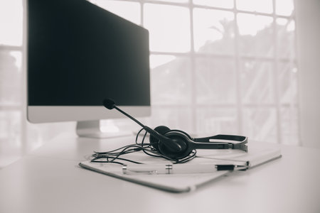 Communication support, call center and customer service help desk. VOIP headset on telephone keyboard.の写真素材