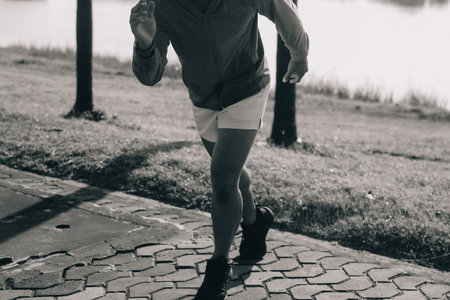 Athlete runner feet running on road, Jogging concept at outdoors. Man running for exercise.の写真素材