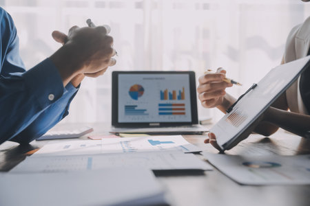 Close up of Business team analyzing income charts and graphs with modern laptop computer. Business analysis and strategy concept.の写真素材