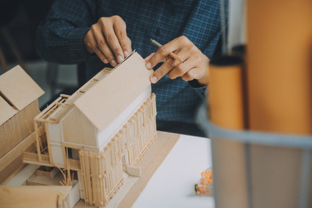 Construction and structure concept of Engineer or architect meeting for project working with partner and engineering tools on model building and blueprint in working site, contract for both companies.の写真素材