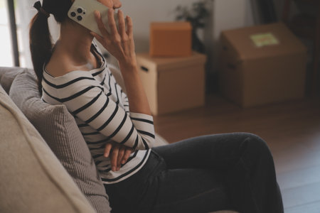 Happiness Entrepreneur beautiful business asian young woman wear casual use mobile phone for shopping online enjoy with social media and laptop at home.Small Business Startup.online bankingの写真素材