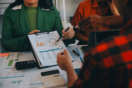 Co working conference, Business team meeting present, investor colleagues discussing new plan financial graph data on office table with laptop and digital tablet, Finance, accounting, investment.の写真素材