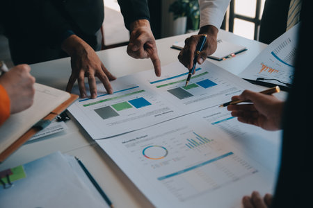 Business team working with new startup project plan and discussion information for financial strategy with laptop and digital tablet in a modern business lounge.の写真素材