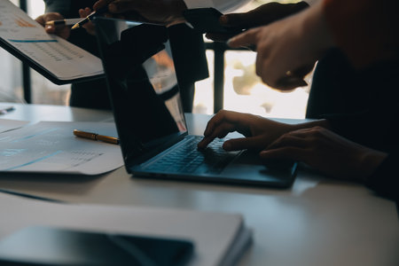 Business team working with new startup project plan and discussion information for financial strategy with laptop and digital tablet in a modern business lounge.の写真素材