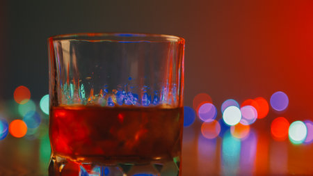 Whiskey splashing out of glass, isolated on white backgroundの写真素材