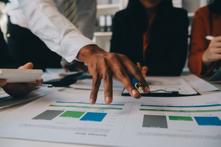 Business team working with new startup project plan and discussion information for financial strategy with laptop and digital tablet in a modern business lounge.の写真素材