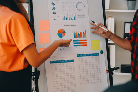 Co working conference, Business team meeting present, investor colleagues discussing new plan financial graph data on office table with laptop and digital tablet, Finance, accounting, investment.の写真素材