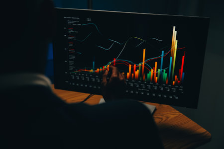 Thoughtful focused successful caucasian male stock investor, broker, financial adviser, sits at work desk, looks at computer, pensively analyze risks and prospects, rise or fall of cryptocurrency coinの写真素材