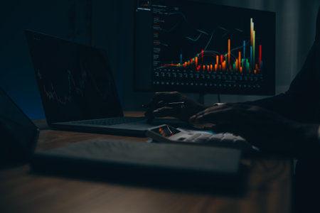 Thoughtful focused successful caucasian male stock investor, broker, financial adviser, sits at work desk, looks at computer, pensively analyze risks and prospects, rise or fall of cryptocurrency coinの写真素材