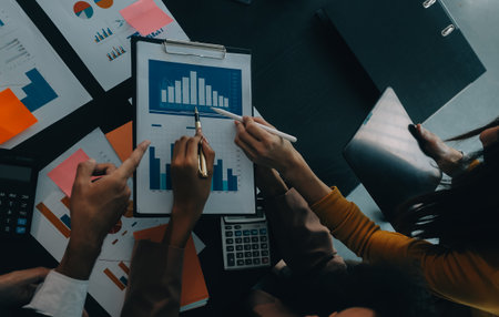 Business team collaboration discussing working analyzing with financial data and marketing growth report graph in team, presentation and brainstorming to strategy planning making profit of company.の写真素材