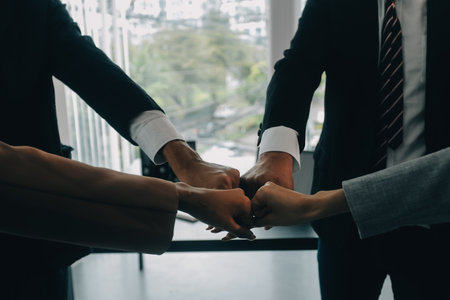 Group of college touch hands for unity group to success business.