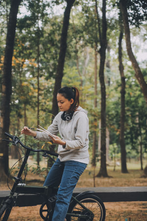 Happy Asian young woman walk and ride bicycle in park, street city her smiling using bike of transportation, ECO friendly, People lifestyle concept.の写真素材