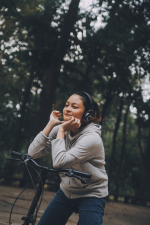 Happy Asian young woman walk and ride bicycle in park, street city her smiling using bike of transportation, ECO friendly, People lifestyle concept.の写真素材