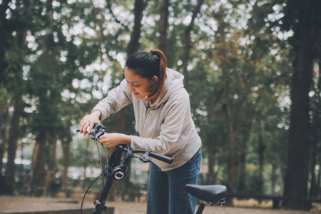 Happy Asian young woman walk and ride bicycle in park, street city her smiling using bike of transportation, ECO friendly, People lifestyle concept.の写真素材