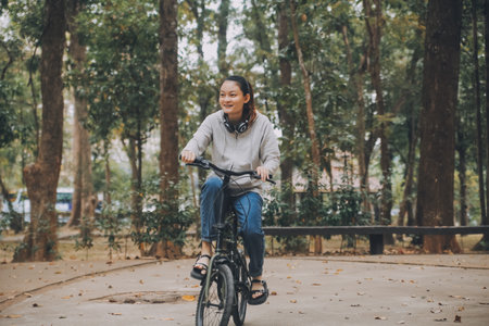 Happy Asian young woman walk and ride bicycle in park, street city her smiling using bike of transportation, ECO friendly, People lifestyle concept.の写真素材