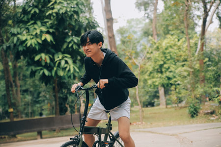 Handsome happy young man with bicycle on a city street, Active lifestyle, people conceptの写真素材
