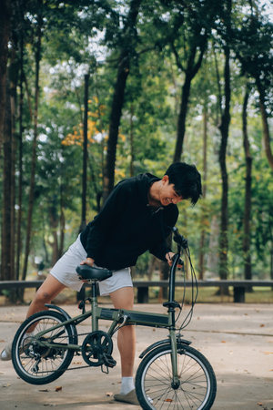 Handsome happy young man with bicycle on a city street, Active lifestyle, people conceptの写真素材
