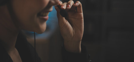 Young woman working in call centre, surrounded by colleaguesの写真素材