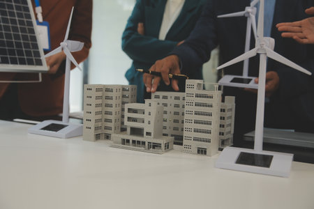 Close-up at tablet, Engineers pointing at tablet with their hands. To jointly design the use of renewable energy with wind and solar energy. Concept of using renewable energy.の写真素材