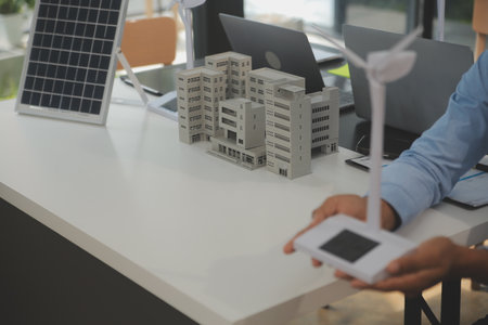 Close-up at tablet, Engineers pointing at tablet with their hands. To jointly design the use of...