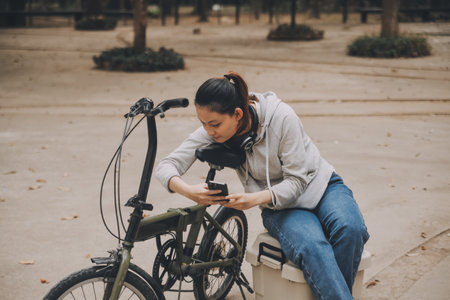 Happy Asian young woman walk and ride bicycle in park, street city her smiling using bike of transportation, ECO friendly, People lifestyle concept.の写真素材