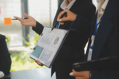 Business team meeting working with new startup project, discussion and analysis data the charts and...