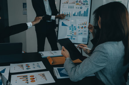 Business team collaboration discussing working analyzing with financial data and marketing growth report graph in team, presentation and brainstorming to strategy planning making profit of company.の写真素材