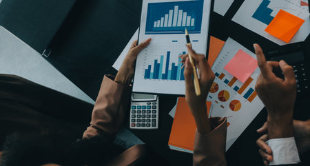 Business team collaboration discussing working analyzing with financial data and marketing growth report graph in team, presentation and brainstorming to strategy planning making profit of company.の写真素材