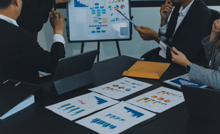 Business team meeting working with new startup project, discussion and analysis data the charts and graphs. Digital tablet, calculator, laptop computer using, Business finance and accounting concept.の写真素材